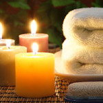 Towel, aromatic candles and other spa objects